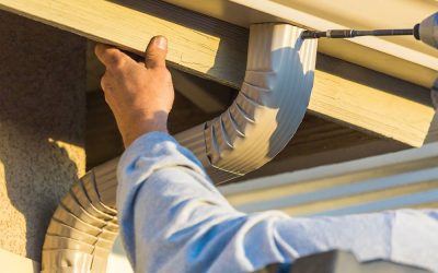 repair man fixing gutter